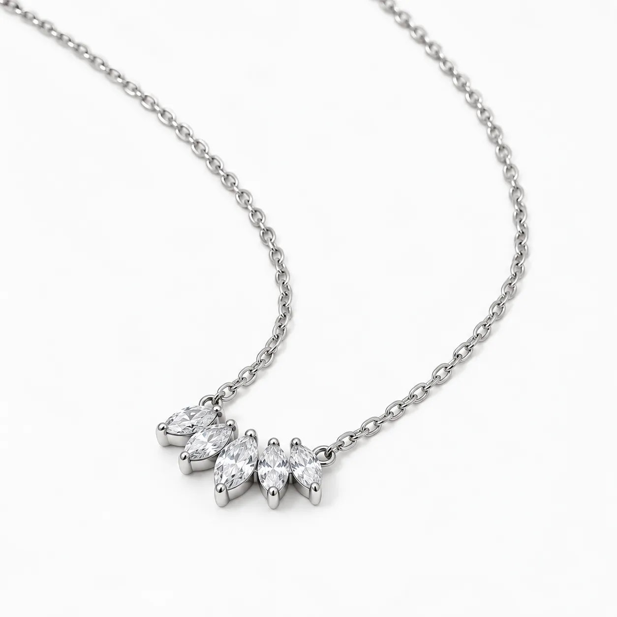 A silver-toned necklace with a delicate chain and a small cluster of marquise-cut clear gemstones in a prong setting, photographed on a clean white background.